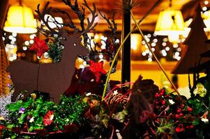 christmas decorations in a window at night photo