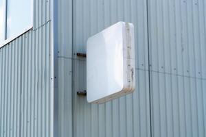 Rectangular light box with company name on concrete building wall. Concept of advertising and marketing. mock up photo