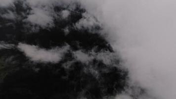 Drone flying through clouds. Cloud background. Clouds and mountains from the air. Smooth flight down to the ground through thick clouds video