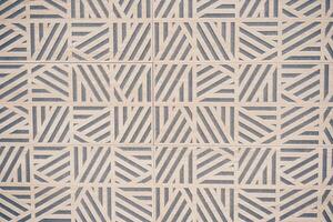Light stone tiles with an original pattern of lines in a geometric style. Stone texture with space to copy photo