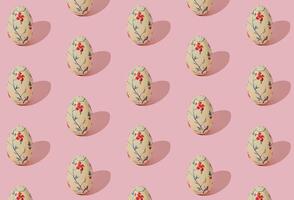 Easter pattern composition made with floral vintage Easter eggs on light pink background. Minimal Easter concept. Creative festive holiday layout. Spring pattern backdrop. photo
