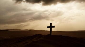 Wooden cross stands on a sand dune as dark clouds gather ominously overhead, creating a dramatic and spiritual scene video