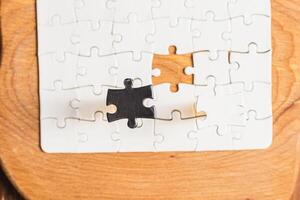Opposite day concept using white and black puzzle pieces on a white background photo