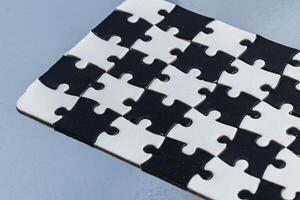 Black and white puzzle, teamwork challenge concept photo