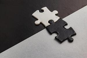 Opposite day concept,white and black puzzle pieces with oposite background color photo
