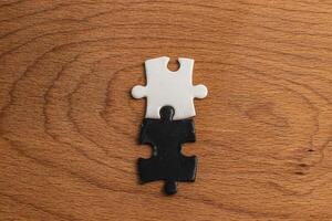 A black and white puzzle piece fit for a concept of yin yang or opposites photo