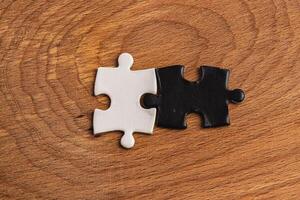 A black and white puzzle piece fit for a concept of yin yang or opposites photo