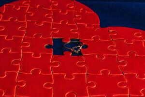 Love concept. Broken heart puzzle with wedding ring, missing puzzle pieces photo