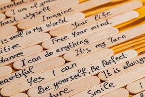 Positive thoughts for increasing selfesteem on wooden posts on wooden background photo