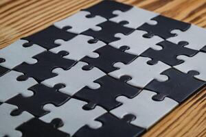 Black and white puzzle, teamwork challenge concept photo