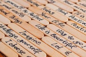 Positive thoughts for increasing selfesteem on wooden posts on wooden background photo