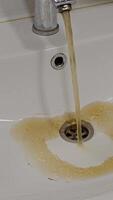 Dirty water flows from the tap into the sink. Contamination of drinking water in the apartment is a problem. Contamination of tap water. video