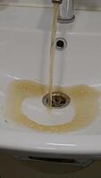 Dirty water flows from the tap into the sink. Contamination of drinking water in the apartment is a problem. Contamination of tap water. video