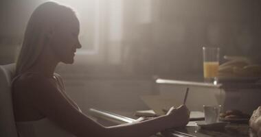 Professional artist drawing sketch in notebook while preparing for work video