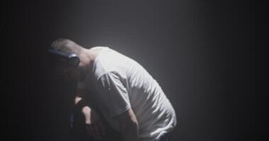 Heavy breathing dancer in spotlight video