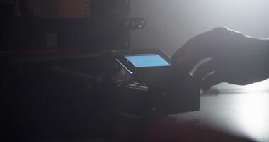 Anonymous engineer using display of 3D printer video