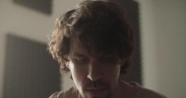 Inspired man playing music at home video
