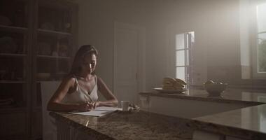 Young female composer composing music in apartment video