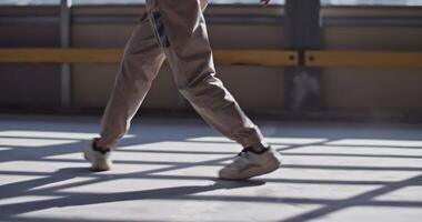 Anonymous dancer walking on sunlit floor video