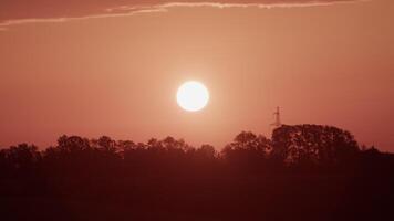 Bright sun shining in orange cloudy sky in sundown time video