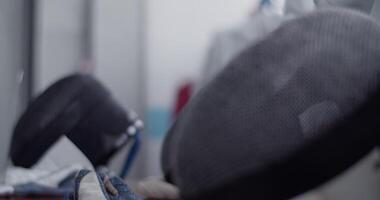 Fencing masks on bench in dressing room video