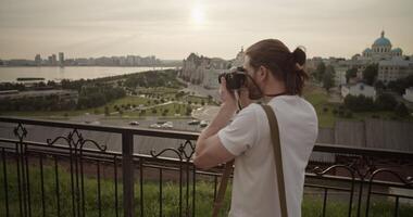 Male photographer taking photo of city during journey video