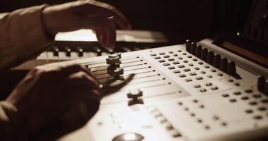 Producer using mixing console in studio video