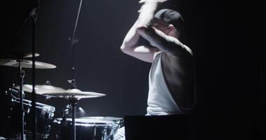 Cool young drummer practicing beats on cymbals on stage video