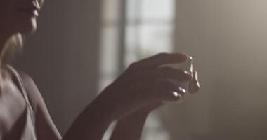 Female composer working in dark room and drinking coffee video