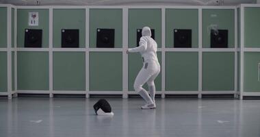 Anonymous Muslim fencer practicing in gym alone video