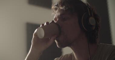 Guitarist with coffee at desk with netbook video