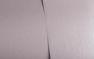 Soft gray paper texture with a satin metallic finish in taupe and sepia tones, featuring a subtle photo