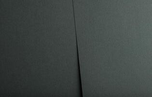 Dark green paper texture with an embossed wavy pattern and deep teal undertones. This matte surface photo