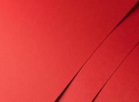 Scarlet red paper texture with a smooth, vibrant surface and bold overlapping lines. The rich, warm photo