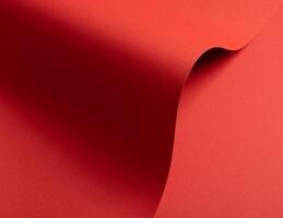 Rich scarlet red paper texture with dynamic wavy shapes and subtle gradients. The rough yet elegant photo