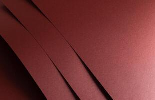 Burgundy red metallic paper texture with a pearlescent finish and a sleek, smooth surface. The warm photo