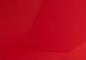 Scarlet red paper background with a rich, vibrant gradient and smooth texture. Premium material with photo