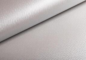 Pearl off-white gray paper texture with a glossy satin sheen and wavy patterns. The creamy, greige photo