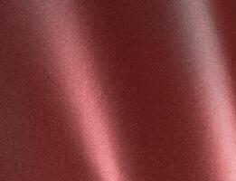 Burgundy red metallic paper texture with a pearlescent finish and warm red-brown tones. The glossy photo