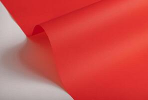 Elegant scarlet red paper background with a fine texture and subtle gradient. Featuring soft folds photo
