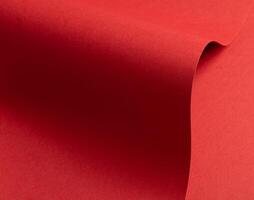 Crimson red paper texture with subtle wavy shapes and a matte finish. The vibrant, rich tones and photo