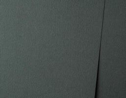 Dark green paper texture with an embossed, wavy leather like pattern in deep teal and forest green photo