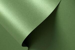 Luxurious green paper background with a smooth satin texture and subtle metallic sheen. Monochrome photo
