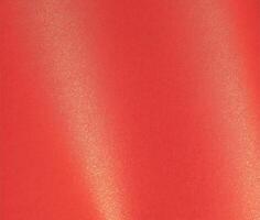 Elegant paper background with a gradient blending scarlet, red, and golden tones. Glossy and sleek photo