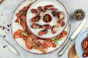 Elegant appetizer featuring bacon-wrapped dates. photo
