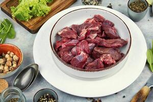 Sliced raw venison deer meat for a stew. photo