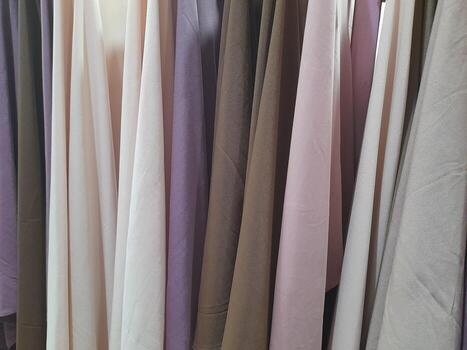 a close-up view of a light-colored fabric surface. The texture appears soft and smooth, with subtle creases and wrinkles running horizontally across the material. photo