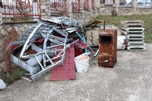 A Collection of Abandoned Scrap Materials Found in a Rustic and Overgrown Setting photo
