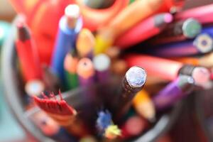 A Bright, Colorful and Dynamic Collection of Various Art Supplies Displayed Within a Jar photo
