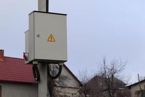 Electrical Utility Box mounted on Power Pole for various utility services and support functions photo